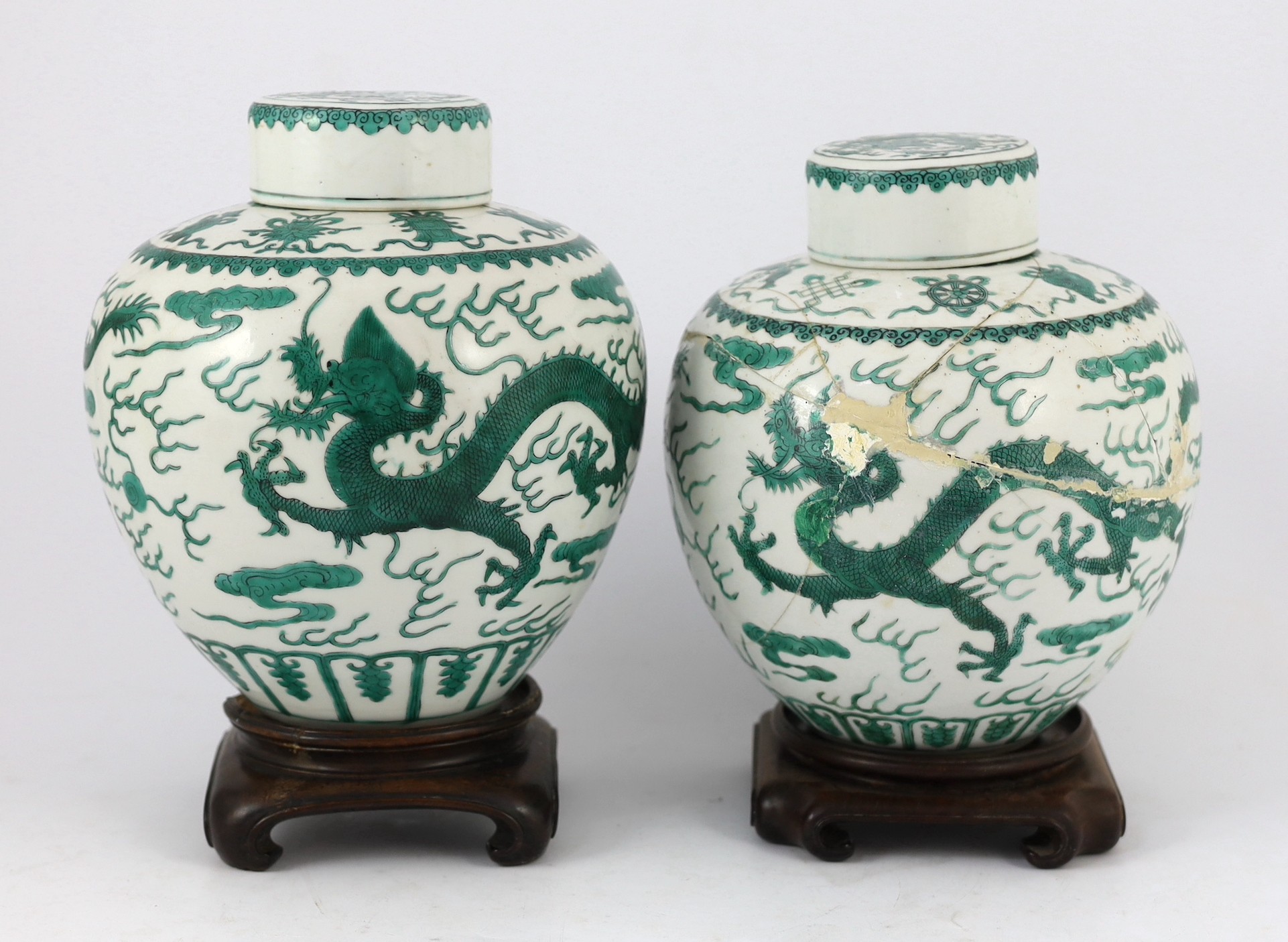 Two similar Chinese green enamelled ‘dragon’ jars and covers, Daoguang mark and period (1821-50), 21.5cm high, damaged and repaired